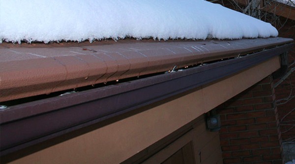 Roof with snow and gutter.